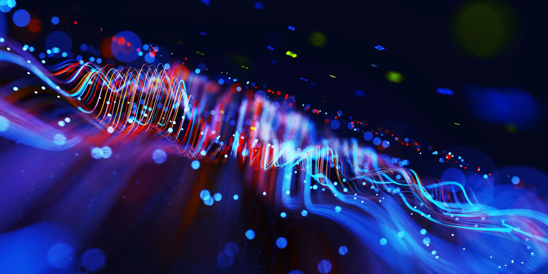 Digital generated image of abstract flowing data made out of glowing blue and red splines moving away from camera on black background.